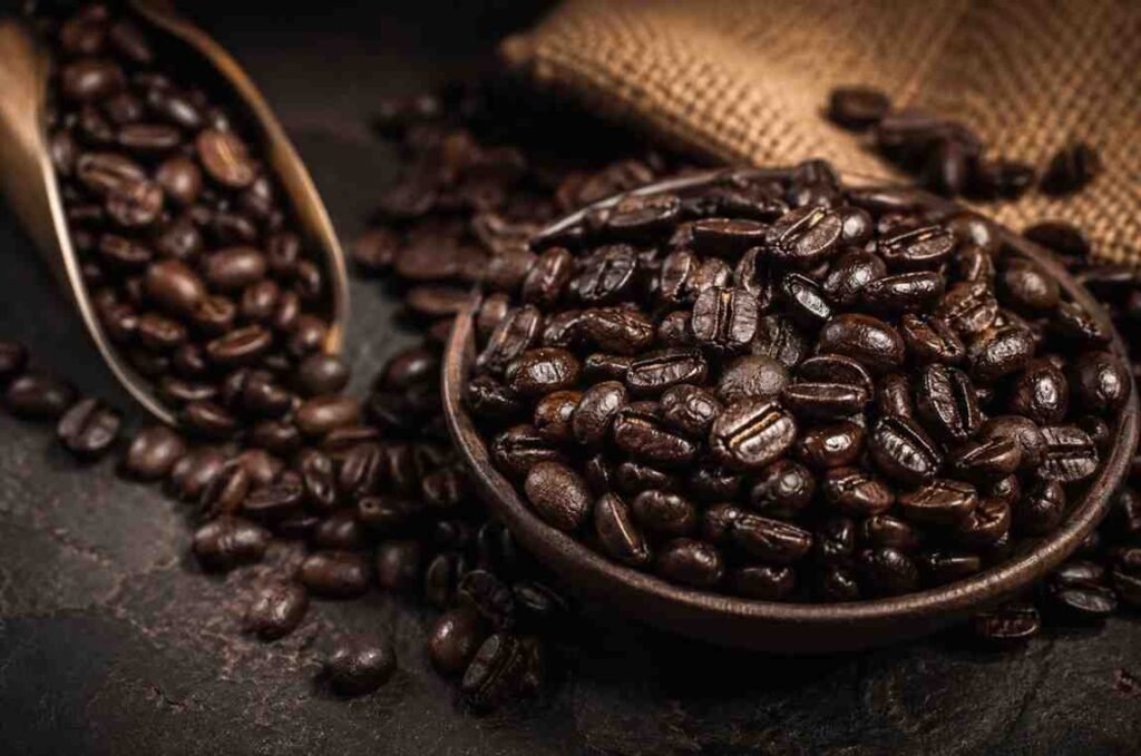 Dark oily French roast coffee beans in a bowl