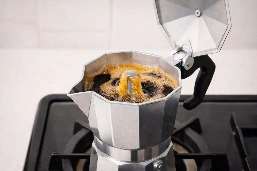Italian coffee brewing process using a moka pot on a stovetop, showing step-by-step preparation of strong and rich Italian coffee at home